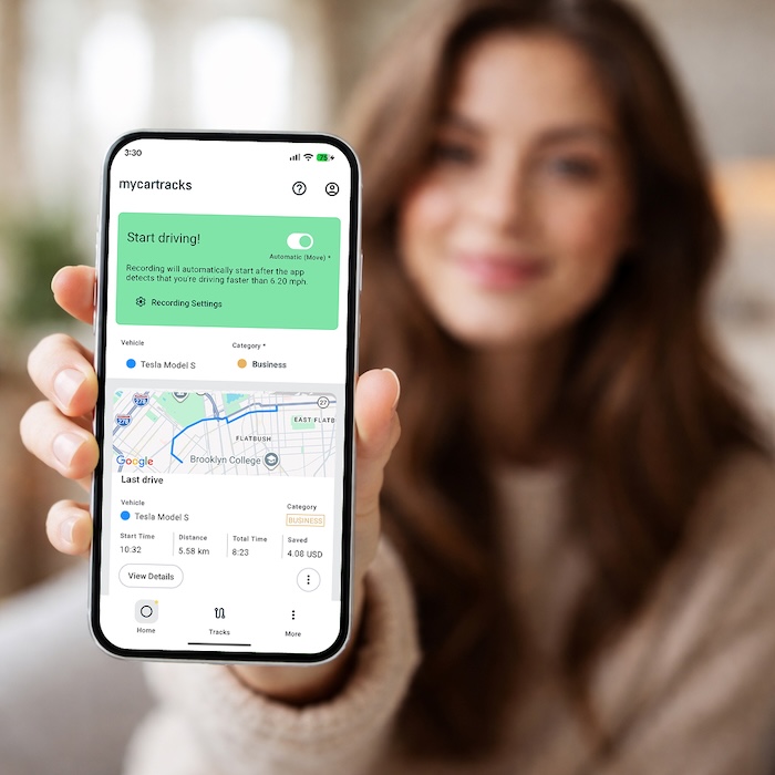 MyCarTracks app on a phone with a woman in the hero image.
